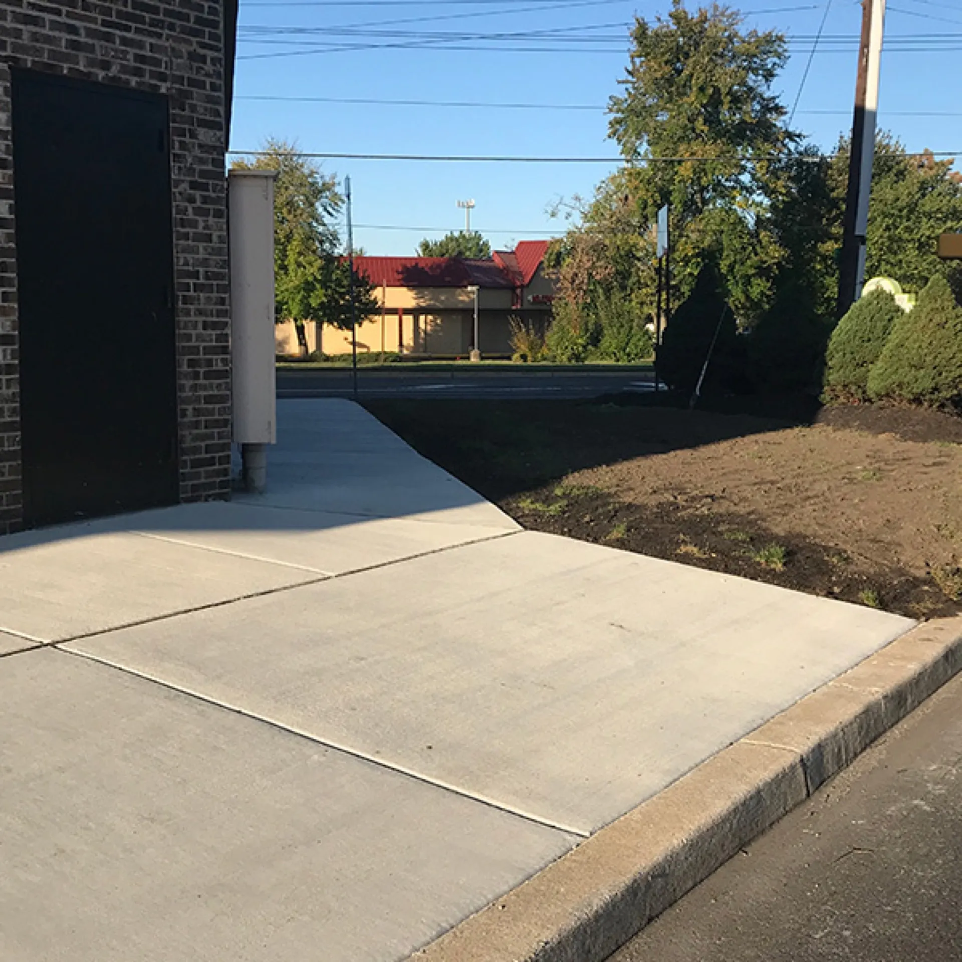 Commercial concrete sidewalk installed next to brick building Cherry Hill NJ