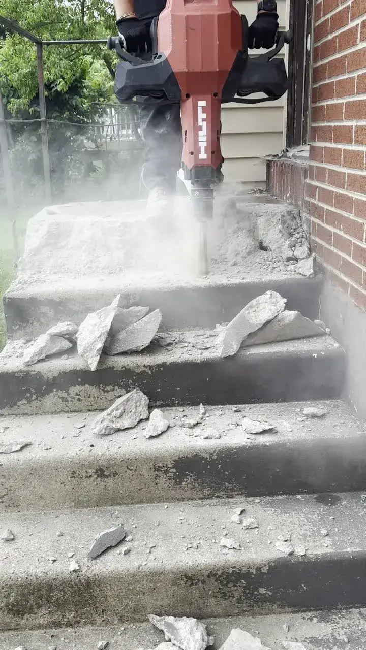 Hydraulic breaker removing old concrete steps at a Cherry Hill, NJ home