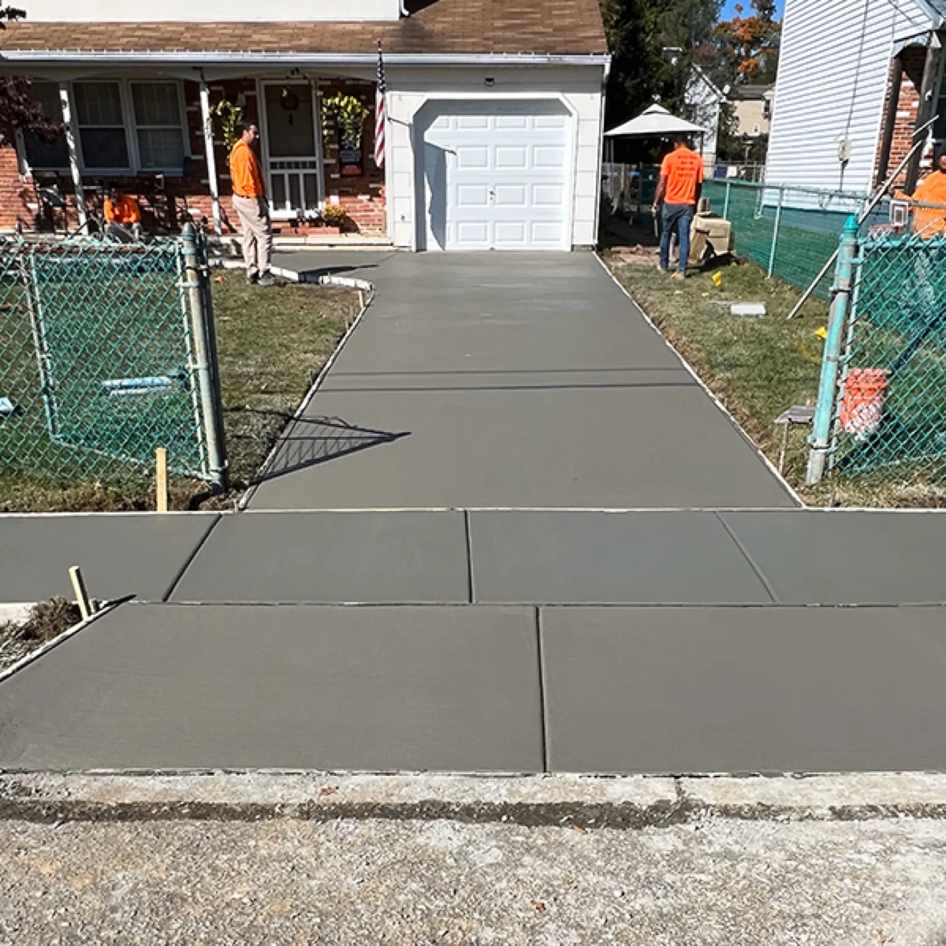 Concrete driveway fresh pour with broom finish crew on site Cherry Hill NJ