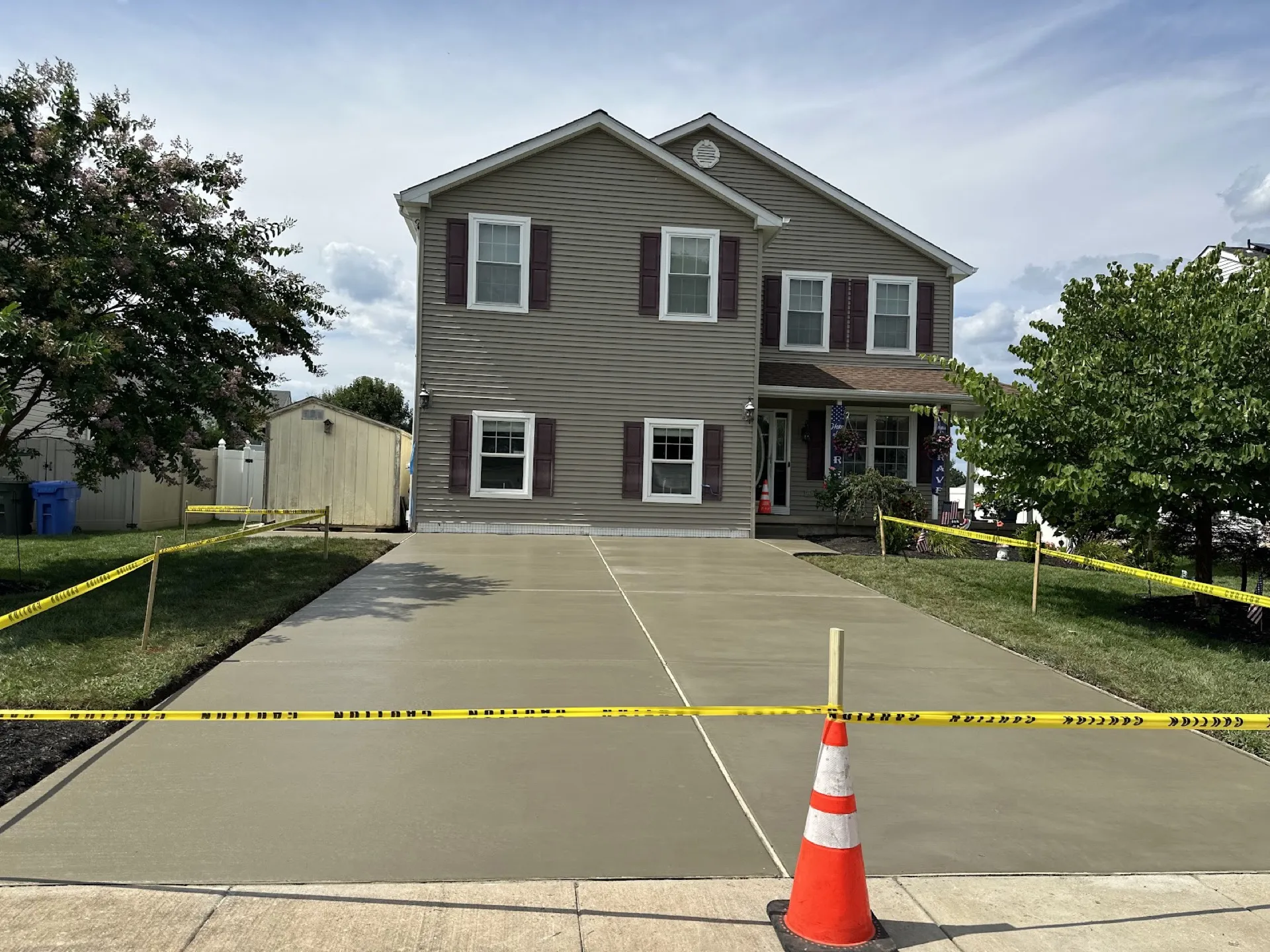 Concrete driveway fresh pour with traffic cone and caution tape Cherry Hill NJ