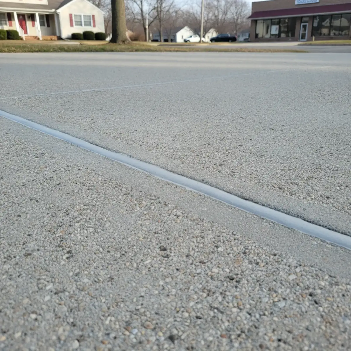 Close-up of a filled and sealed crack in a concrete driveway in Cherry Hill, NJ