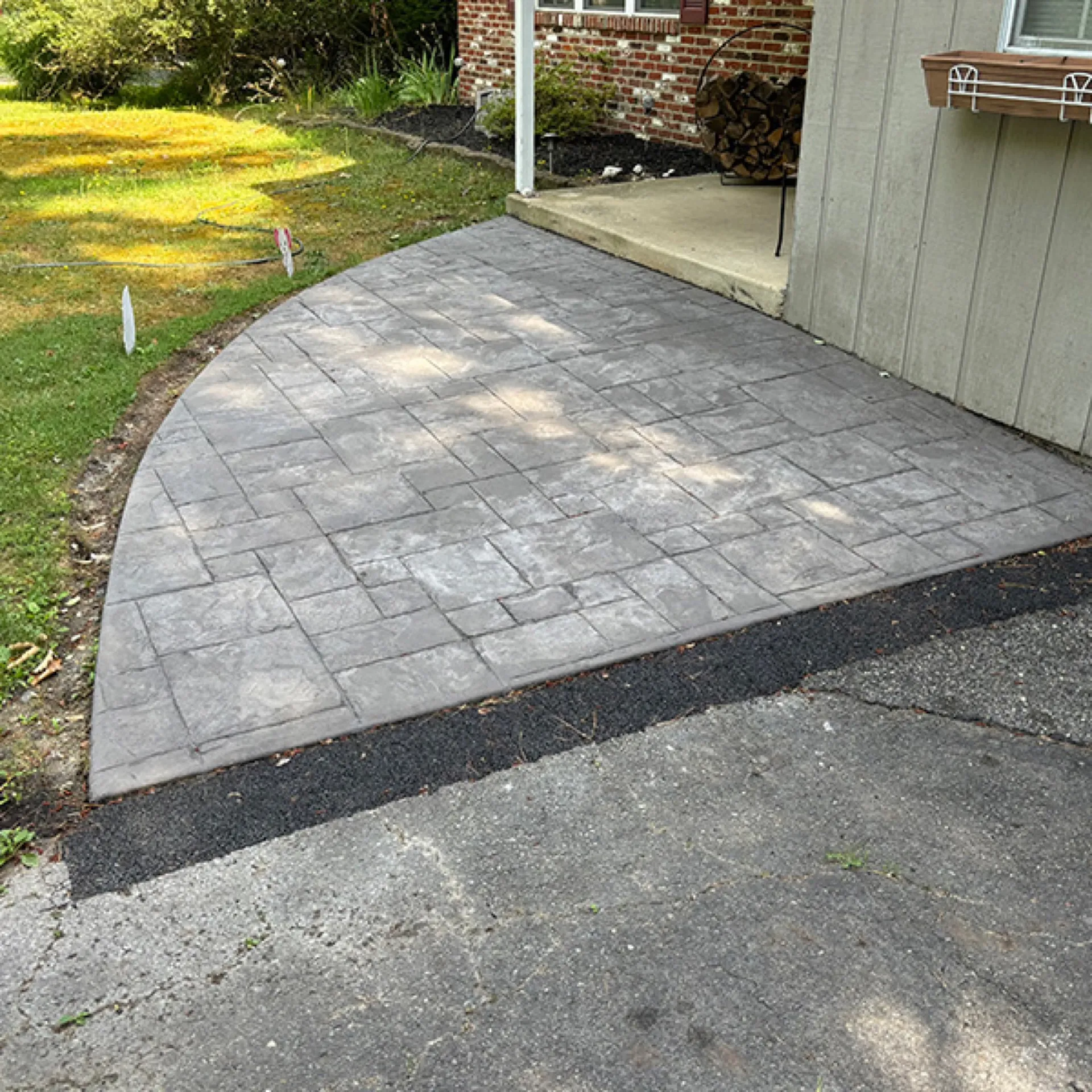 Curved stamped concrete parking pad with stone tile pattern Cherry Hill NJ